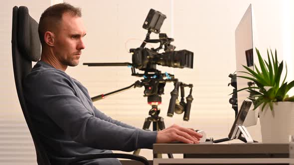 FIlm Post Production Worker In Front of Desktop Computer Editing Video Clips alt
