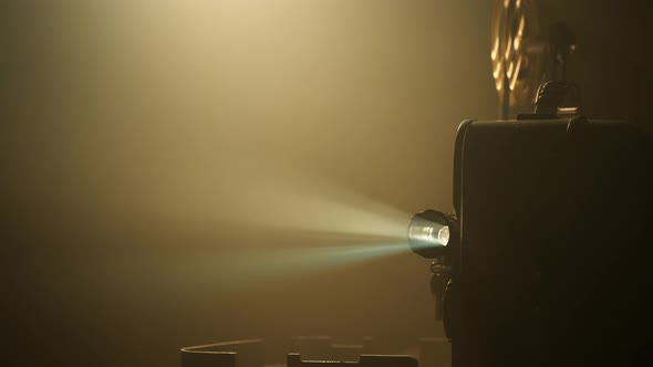 Vintage Movie Projector Projecting Film in a Room alt