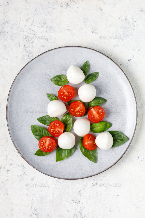 Caprese salad in the form of a Christmas tree. Festive tomato mozzarella and basil appetizer