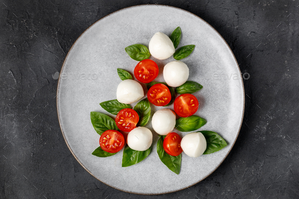 Caprese salad in the form of a Christmas tree. Festive tomato mozzarella and basil appetizer