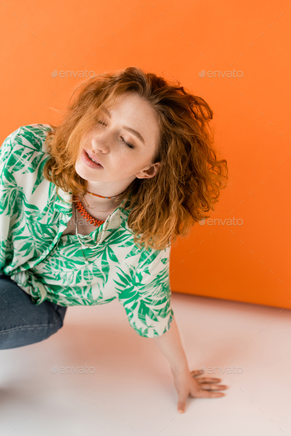 Portrait of a beautiful woman wearing red blouse, casual jeans and