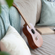 ukulele, books and pillows on the couch. Cozy trendy hipster apartment interior.  - PhotoDune Item for Sale