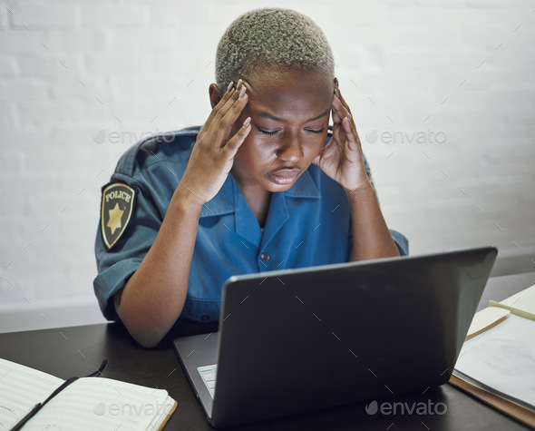 Police, woman with headache and working with stress on computer or frustrated with case, report or