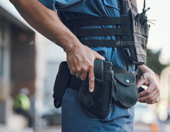 Security, police and hands of man with gun in city for shift, inspection and supervision on patrol.