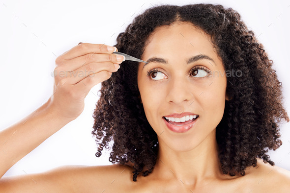 Woman, beauty and face with tweezers for eyebrow in studio, white background and aesthetic change.