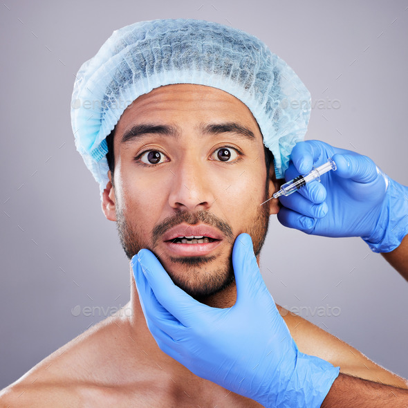 Hands, portrait and plastic surgery with a man in studio on a gray background for a botox injection