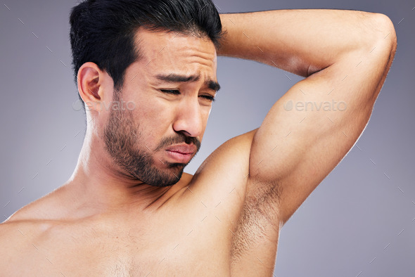 Armpit, smell and man with body odor in studio isolated on a white background for deodorant, cleani