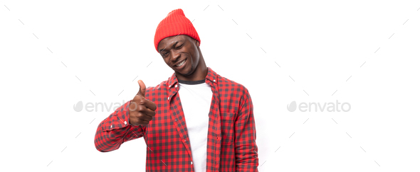 confident young ethnic african guy in stylish look pointing with index finger at promotional offer