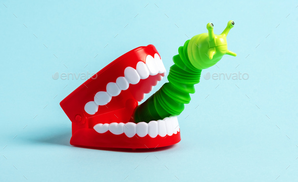 Green worm crawls out of human jaw. Halloween greeting card. Bad breath concept.
