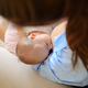 Mother feeding newborn baby in room - PhotoDune Item for Sale