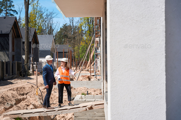 General contractor and forewoman inspecting interior of house under construction