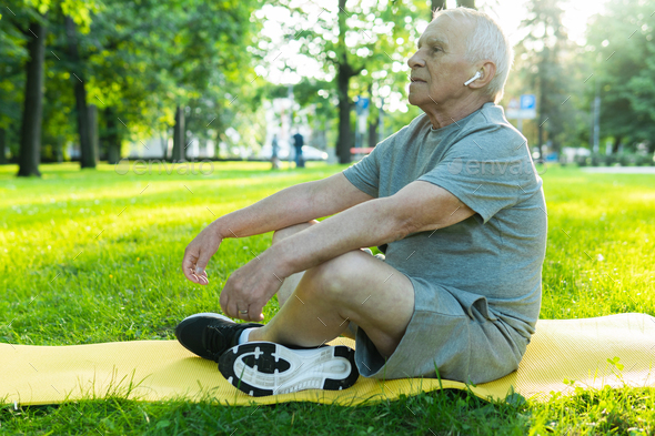 Middle Aged Man Relaxing In Garden Stock Photo by