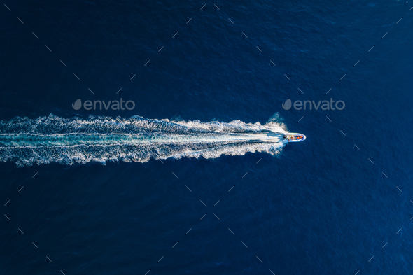 Vacation and leisure. Aerial view on fast boat on blue Mediterranean sea at sunny day.