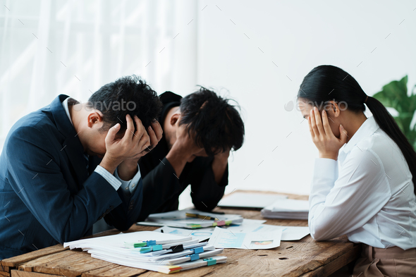 Tired, stress and business people in a meeting with a headache, problem and team depression. Sad, an