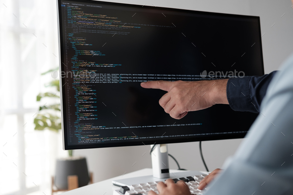 Team of programmer pointing to desktop computer with developing programming code, trying to solve  - Stock Photo - Images