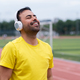 Energized sportsman at city sports stadium listens to his favorite music  through wireless headphones Stock Photo by demopicture