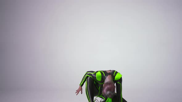 Front View Slim Artistic Young Woman with Dazzling Makeup in Bright Costume Doing Front Handspring alt