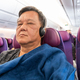 Passenger cover himself with wool blanket provided by airline during longhaul flight for warm and - PhotoDune Item for Sale
