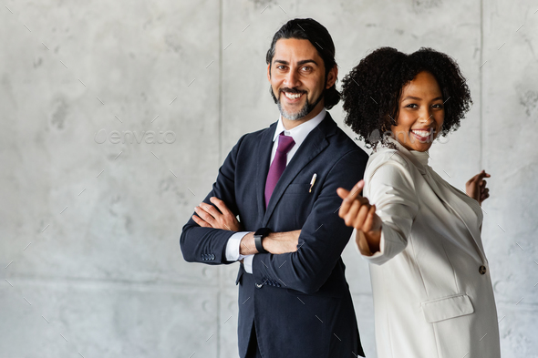 Funny positive multiethnic business team posing over marble wall background  Stock Photo by Prostock-studio