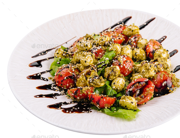 salad with tomatoes and mozzarella cheese with basil leaves and strips of soy sauce