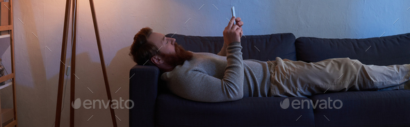 mobile interaction, bearded man with red hair using smartphone
