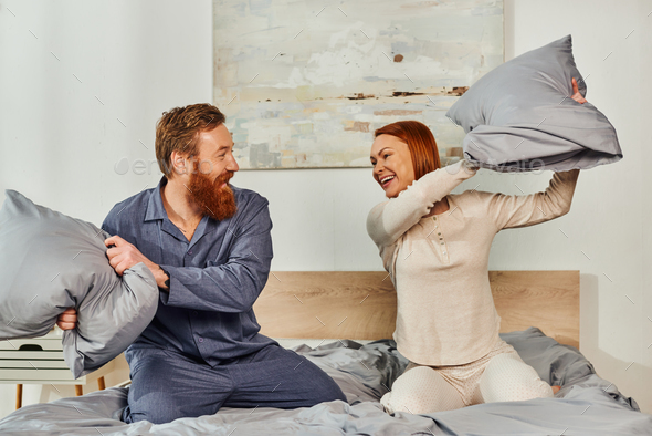 day off without kids,having fun,pillow fight,redhead husband and wife
