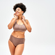 Full length of barefoot and sexy african american model in modern brown  lingerie touching shoulder Stock Photo by LightFieldStudios