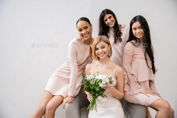 wedding photography, cultural diversity, four women, joyful bride with bouquet and bridesmaids