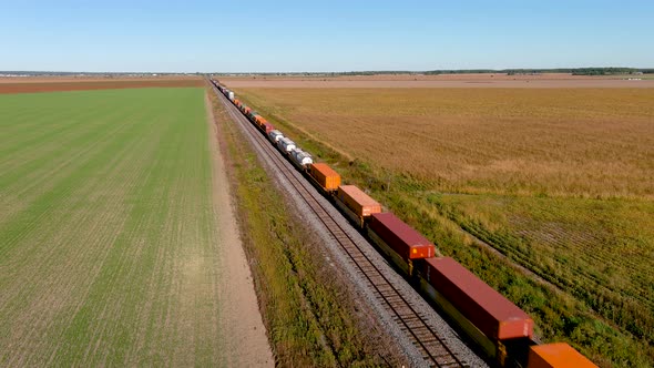 4K UHD drone aerial footage of a train in motion on countryside.