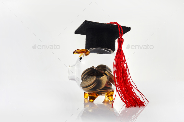 Graduation Hat With Transparent Piggy Bank. College education costs, tuition financial aid.