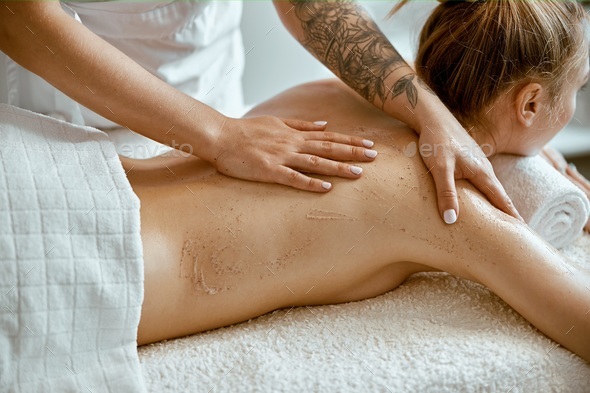 Caucasian woman getting a back massage in the spa salon Stock