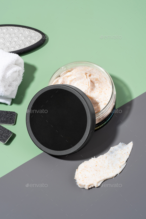 jar of foot scrub with softening effect on a green and gray background.Set of SPA cosmetic products