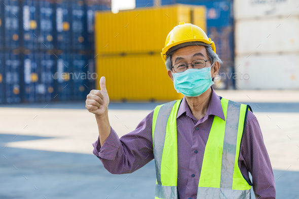 healthy elder senior worker with face mask thumb up. Asian chinese old man engineer staff foreman