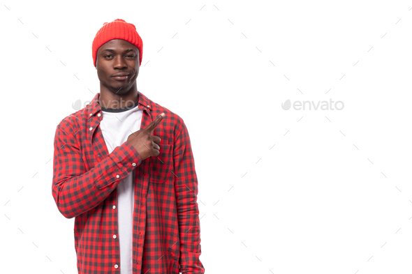 handsome young ethnic african guy in red plaid shirt telling interesting news and using gestures