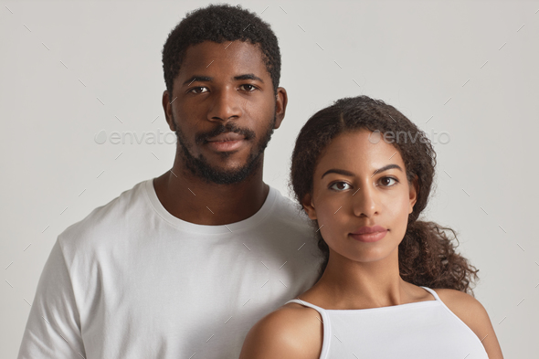 Black couple looking at camera minimal