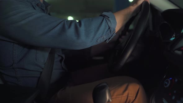 Man Driving in Innovative Automated Car Using Self-parking Autopilot for Parking on Parking Lot alt