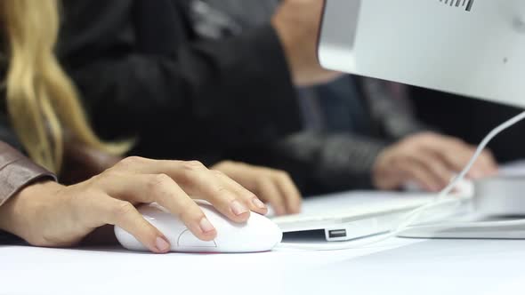 Woman Using A Modern White Computer Mouse