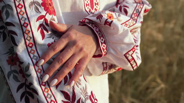 Ukrainian Woman Demonstrating Beautiful Details of Embroidery Ornament on Vyshyvanka Shirt alt
