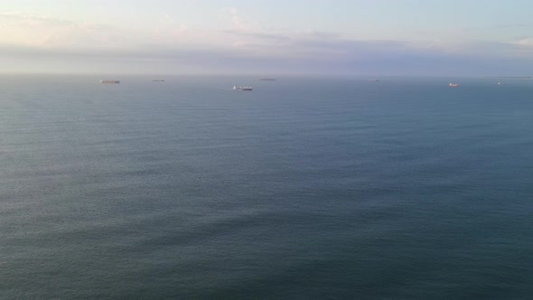 Landscape Shot of Ocean with Freight Ships Seen in Background