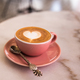 Pink cup of cappuccino with beautiful latte art on marble table background. - PhotoDune Item for Sale