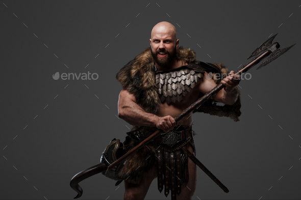 Viking man in a beard and bald head against a gray background