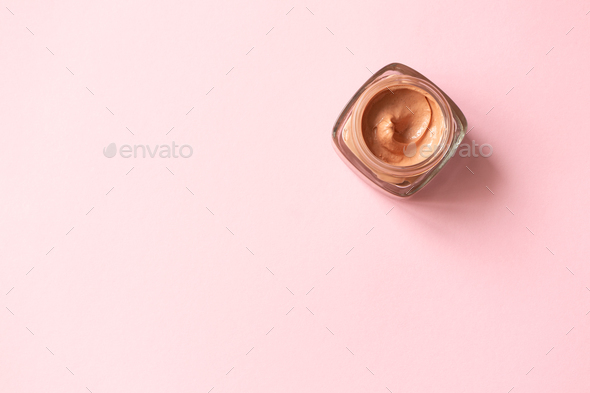 Facial pink clay mask for sensitive skin on pink background