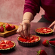 Female hand putting strawberries into a pie - PhotoDune Item for Sale