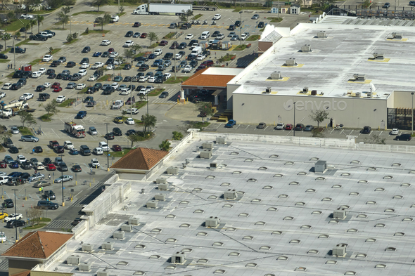 View from above of american grocery store with many parked cars on parking lot