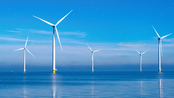 offshore windmill park with clouds and a blue sky - Stock Photo - Images