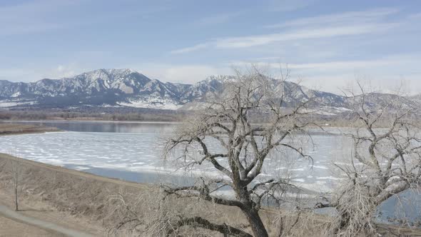 Fly Over Tree View Of Frozen Lake Boulder Colorado Sunny Day alt