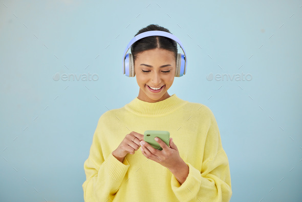 Woman with phone, headphones and mockup in studio for social media post, mobile app and streaming r