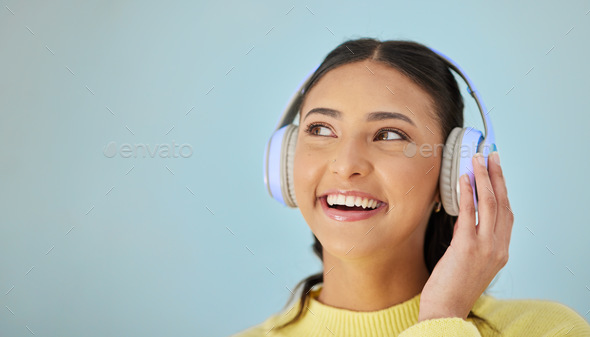 Woman with smile, headphones and mockup in studio for social media post, mobile app and streaming r