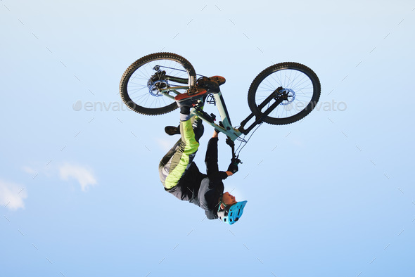 Bike, man and upside down in sky for action, bicycle stunt and challenge on mockup space. Biker, sp