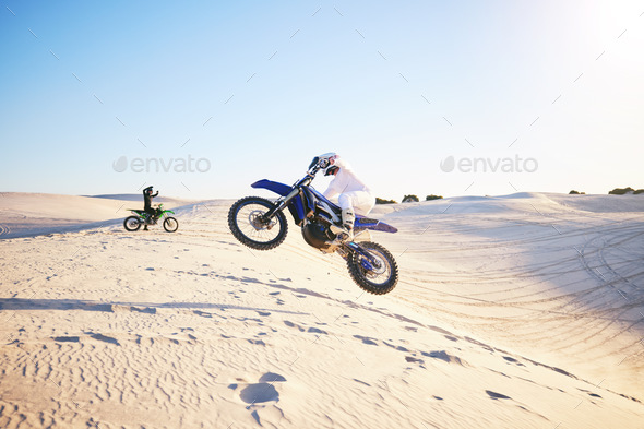 Motorcycle, desert race and jump in air for competition, stunt and outdoor for performance, goal an